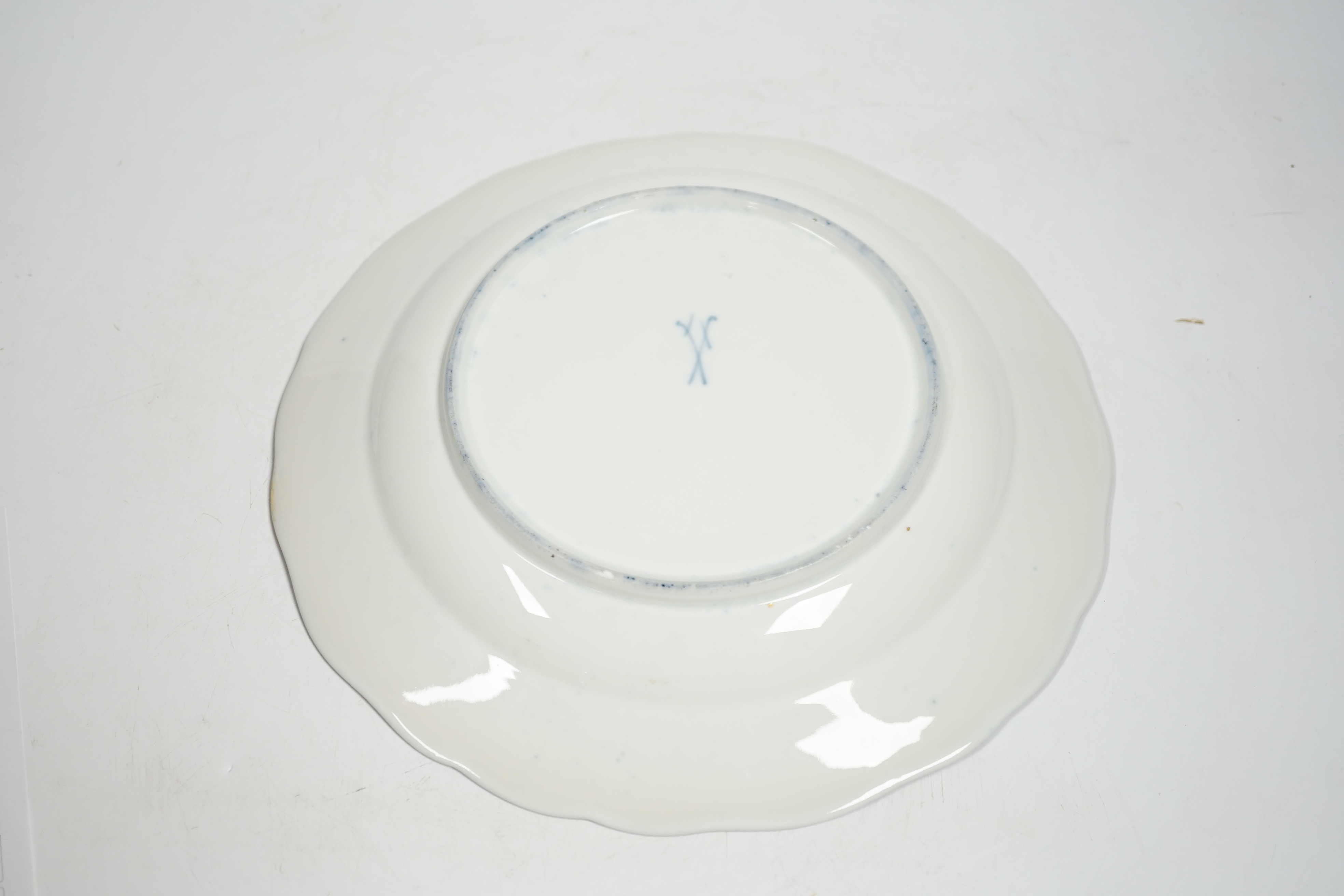 A Meissen-style rich blue and gilt bordered dish, the centre painted with a romantic scene with figures